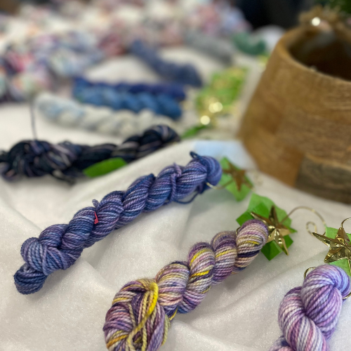 Close-up of Advent mini skeins in cool tones, including blues, greens, and soft neutrals.