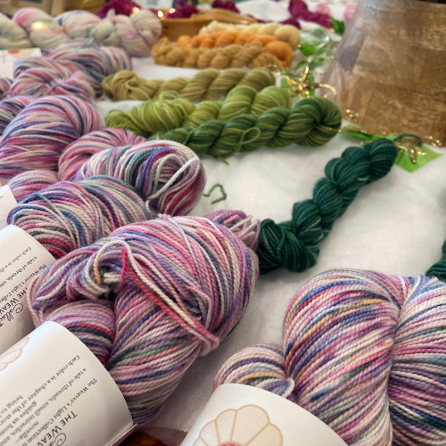 Mini skeins from the Advent collection showing warm earth tones including gold, olive, and soft brown.