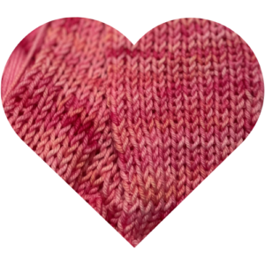 Close-up heart-shaped Heart Rest knit swatch of pink hand dyed yarn showing blush and berry tonal variation.