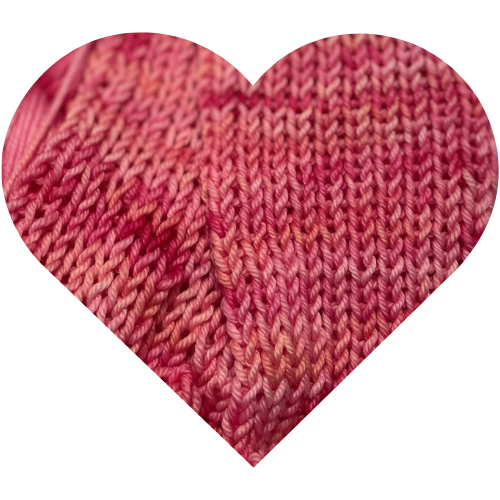 Close-up heart-shaped Heart Rest knit swatch of pink hand dyed yarn showing blush and berry tonal variation.